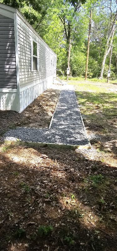 Gravel walkway beside mobile home with staircase access, Anna, TX